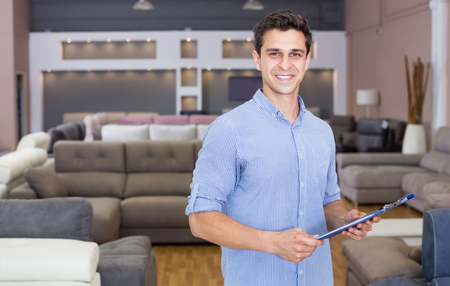 Salesman showing prices in home furnishings storeの写真素材