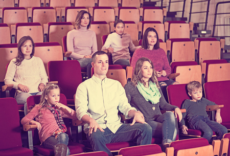 Number of positive young people enjoying film screening in cinemaの写真素材