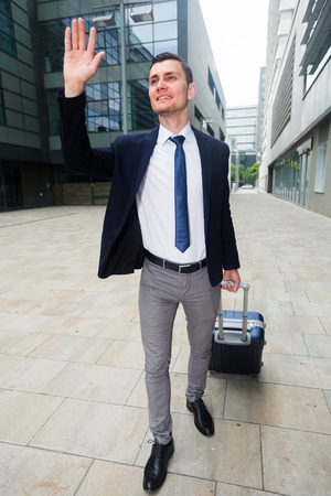 Professional businessman in suit with suitcase is is meeting his partner in another city.の写真素材