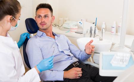 Adult man is consulting with dentist in the hospital.の写真素材