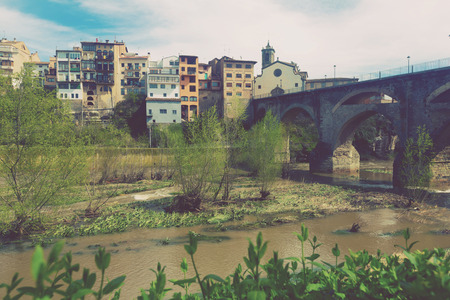 Old bridge at Roda de Ter crossig the river in Cataloniaの写真素材