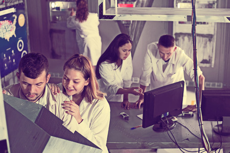 Young people trying to solve conundrum in quest room in view as abandoned labの写真素材
