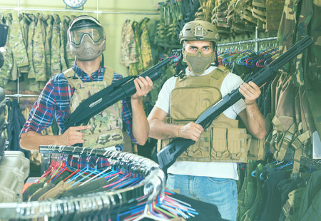 positive french  men in army uniform with gun in military marketの写真素材