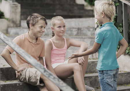 Kids are communicating on walk in the park.の写真素材