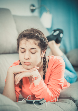 Young teenage girl having problems and depression at homeの写真素材