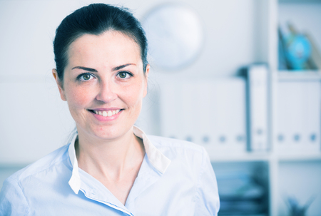 Adult positive employee female working in the modern officeの写真素材