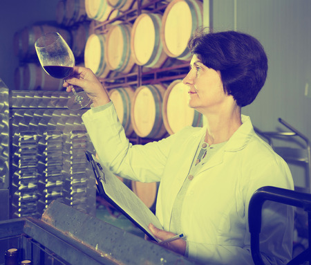 positive american expert estimates quality of red wine on wineryの写真素材