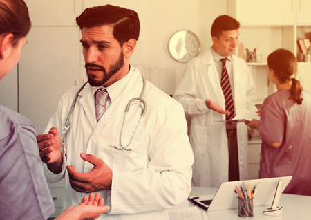 Professional doctors having discussion in medical officeの写真素材