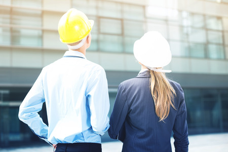 Smiling engineer and woman designer are estimating results of their project on the outside.の写真素材