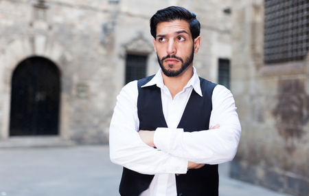 Bearded stylish serious man in strong confident pose arms crossedの写真素材