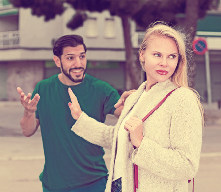 Portrait of female who is angering to adult stranger on the street.の写真素材