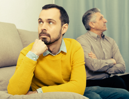 Mature father and son discuss family problems and solve relationship problemsの写真素材