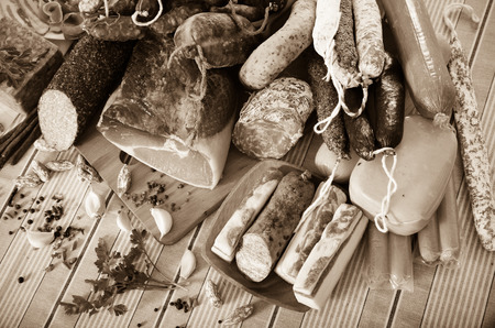 Variety of meats, sausages and mince with herbs on tableの写真素材