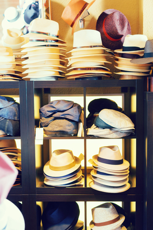 Stylish fedora hats hanging on the wall of country shopの写真素材