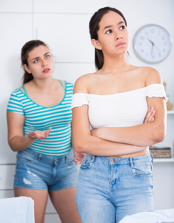 Adolescent girls finding out relationship at homeの写真素材