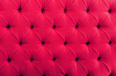 Close up view on bright pink textile texture of sofa