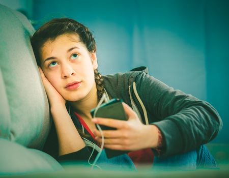 Young teenage girl having problems and depression at homeの写真素材