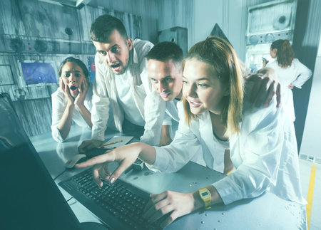 players are searching for a solution to a puzzle in a quest room laboratory