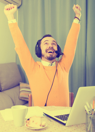 Smiling man learner studying effectively at online courses at homeの写真素材