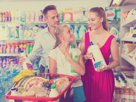 Portrait of charming people showing household goods purchase in the domestic shopの写真素材