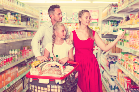 Family with child are choosing goods in shop.の写真素材