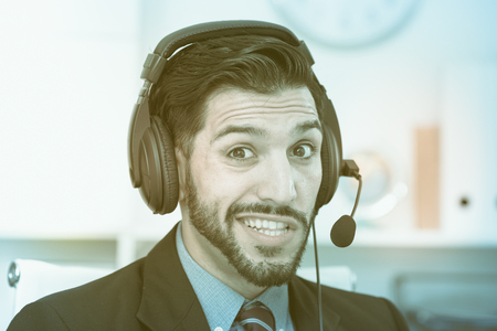 Portrait of spanish man dispatcher who is talking with client in office.の写真素材