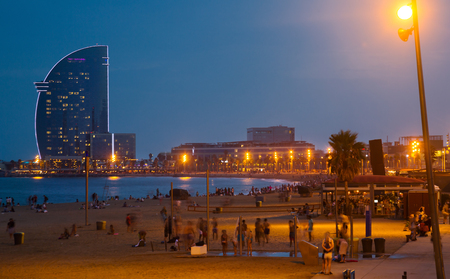 Famous Barceloneta beach in Barcelona with hotel in night lightsのeditorial素材