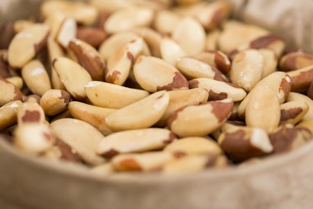 Image of white brasilian nut in container in the store.の写真素材