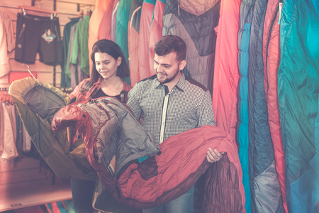 Positive family choosing new sleeping bags in sports equipment storeの写真素材