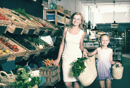 Portrait of adult woman and girl shopping in supermarketの写真素材