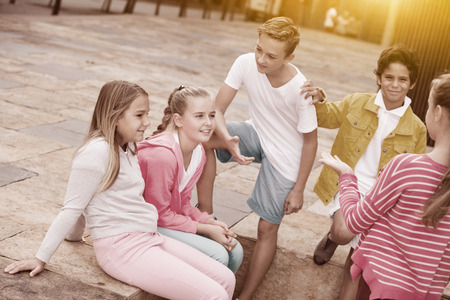Five kids are communicating about football on walk in the park.の写真素材