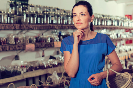 smiling english female customer standing  in biofood shop  の写真素材