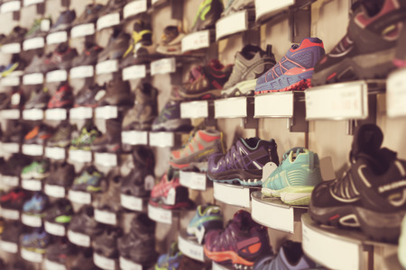 Image of sport colorful shoes on showcase of sports storeの写真素材