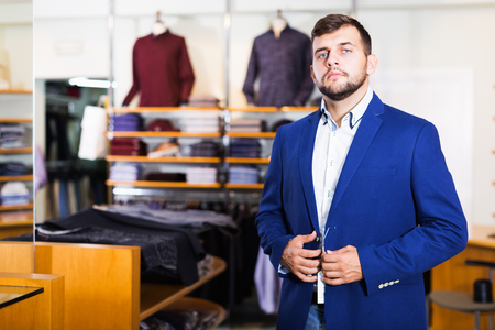  male client  choosing classic jacket in the mallの写真素材