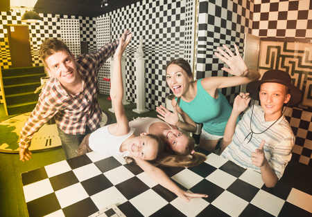 Ordinary family is visiting of escaperoom stylized under chessboardの写真素材