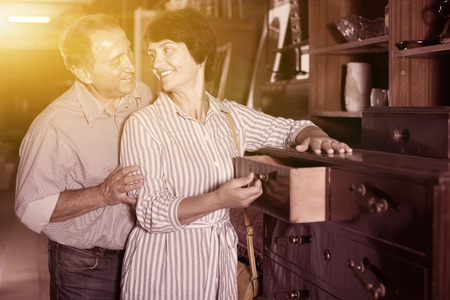 woman with her husband are buying antique curbstone for home in storeの写真素材