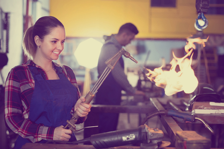 Young woman master is working with burner in workplaceの写真素材