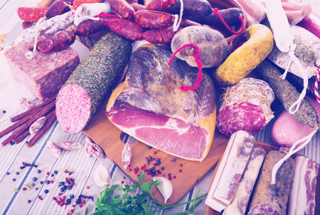 Display of mince, sausages and meat with spices on tableの写真素材