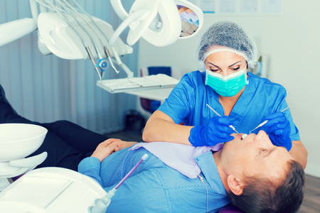 woman dentist in uniform health tooth visitor in dentist's roomの写真素材