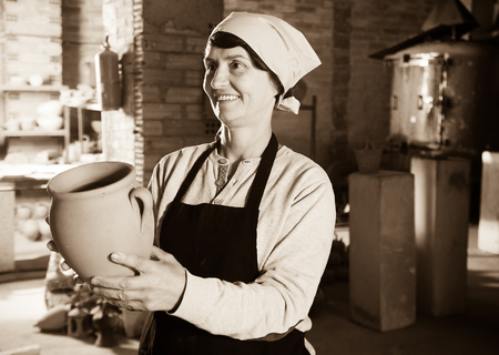 Happy female  potter working at workshopの写真素材