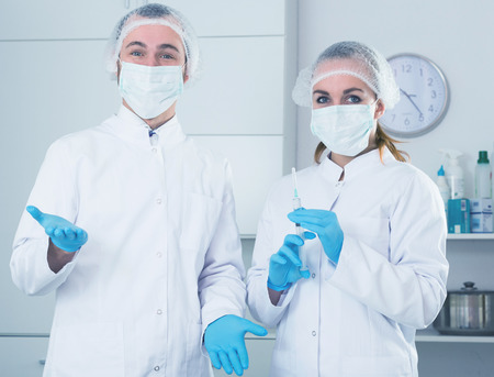 Female nurse and male doctor expecting patients in officeの写真素材