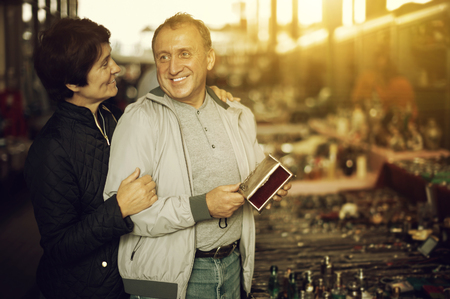 Couple is choosing jewelry box at the antique market outdoorの写真素材