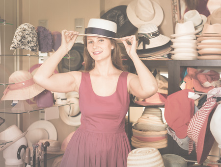 adult smiling  english woman try on hatinator hat  in shopping mallの写真素材