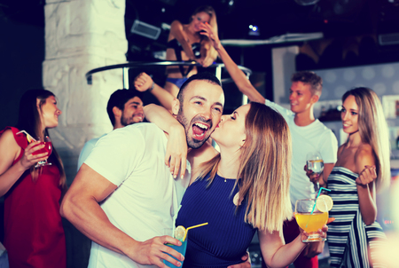 
couple of  happy people together in the night club with drinksの写真素材