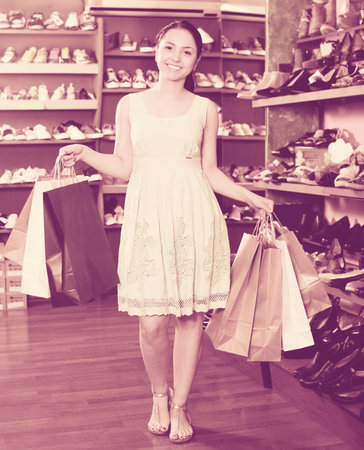 Woman shopper is showing new purchases in fashion shop