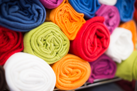 image of different cotton colour towels in the textile shopの写真素材