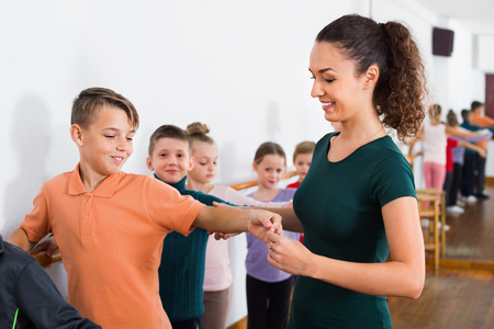Young happy cheerful positive ballet dancers exercising in ballroomの写真素材