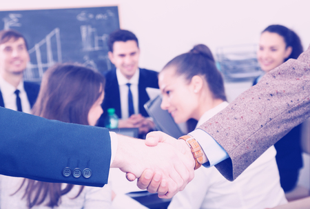 Two european managers shaking hands and celebrating successful dealの写真素材