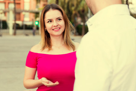 Young female is flirting with guy in the park.