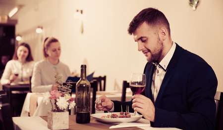 Businessman is having dinner in the restaurante indoor.の写真素材